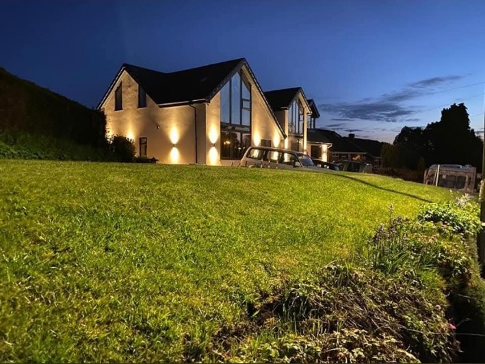 Exterior lighting installation on a house at night