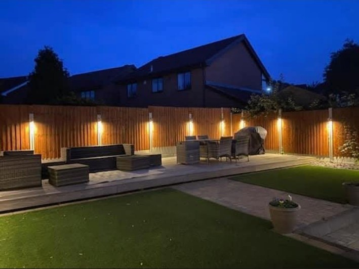 Garden fence and patio lighting at night