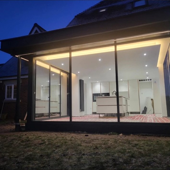 Glass extension with interior lighting at night